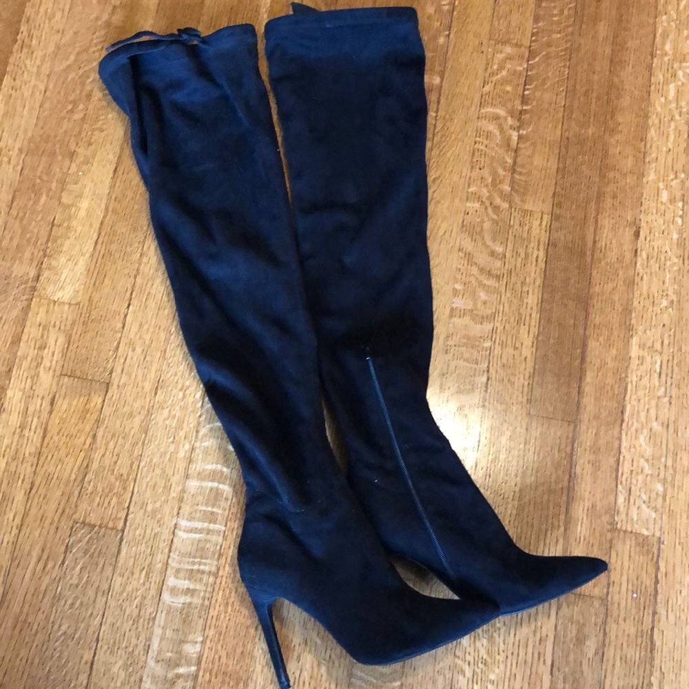 Thigh high black stiletto heels.